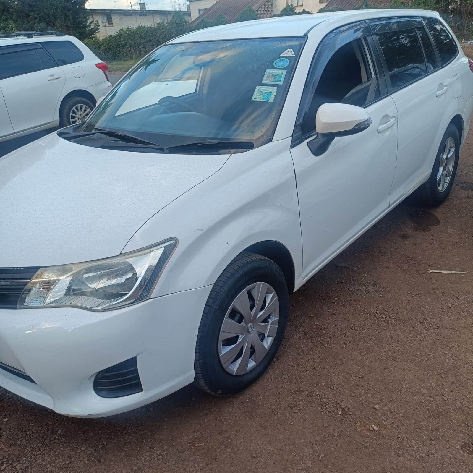 White Toyota Corolla Fielder front-side profile